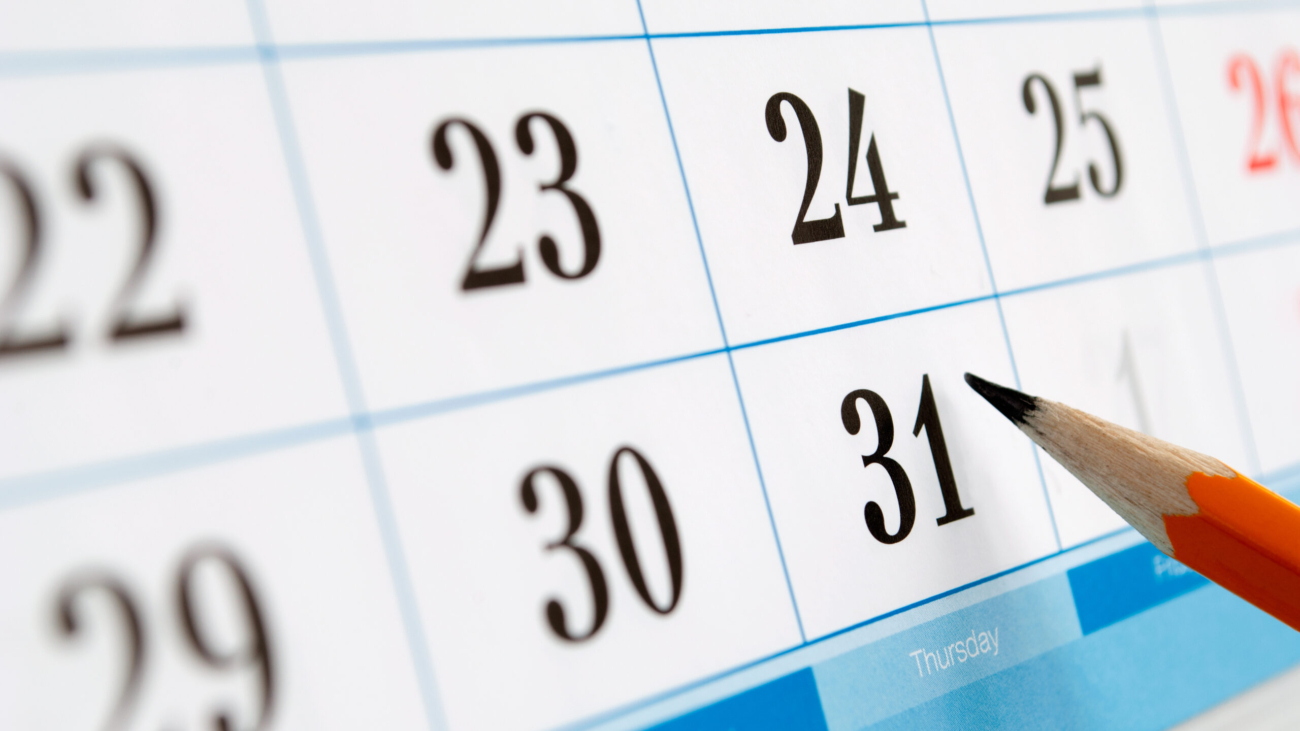 home calendar with dates and yellow sharpened pencil